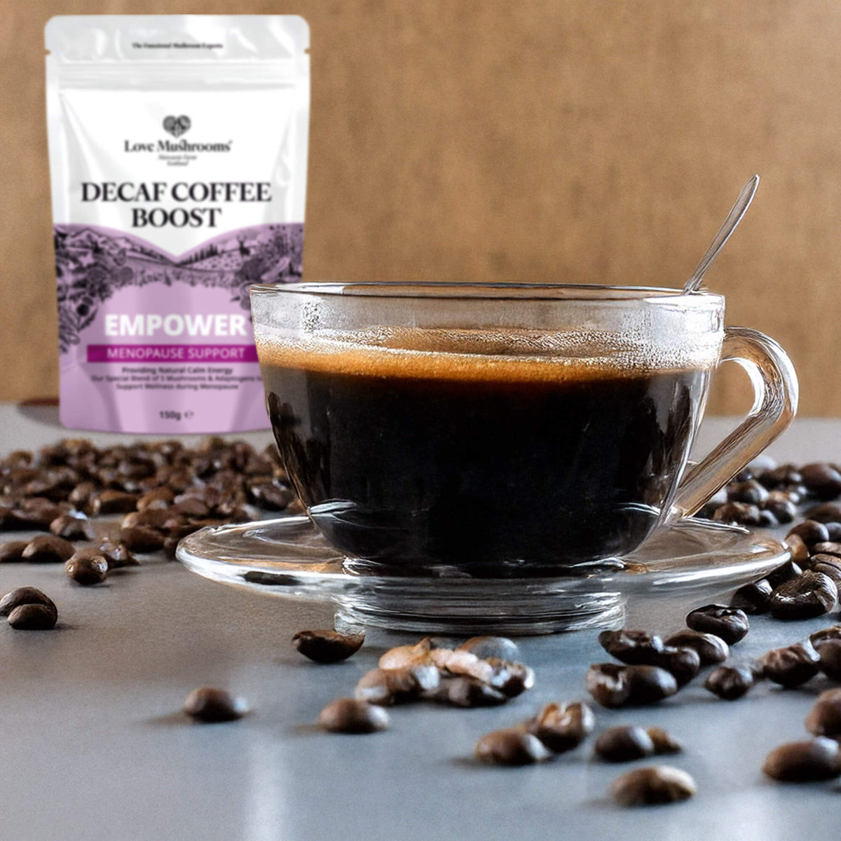 Love Mushrooms Empower menopause support decaf coffee beside a cup of black coffee and coffee beans