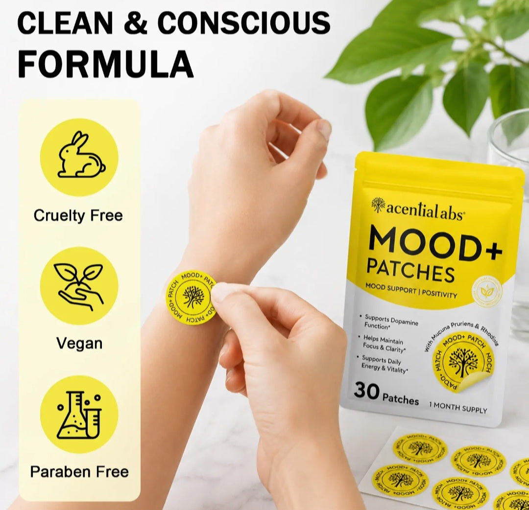 A person applies a round yellow Mood+ patch to their wrist while holding a package of aconialabs Mood+ Patches. The image includes marketing text 'CLEAN & CONSCIOUS FORMULA' and feature icons for Cruelty Free, Vegan, and Paraben Free.
