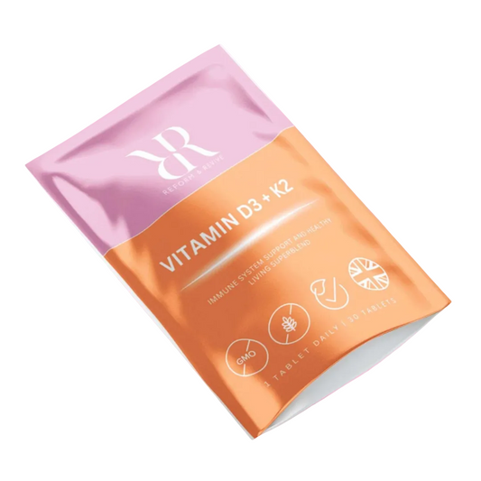 Vitamin supplement package with pink and orange design on a white background