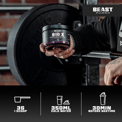 Person holding a container of Beast Big Z supplement with gym equipment in the background