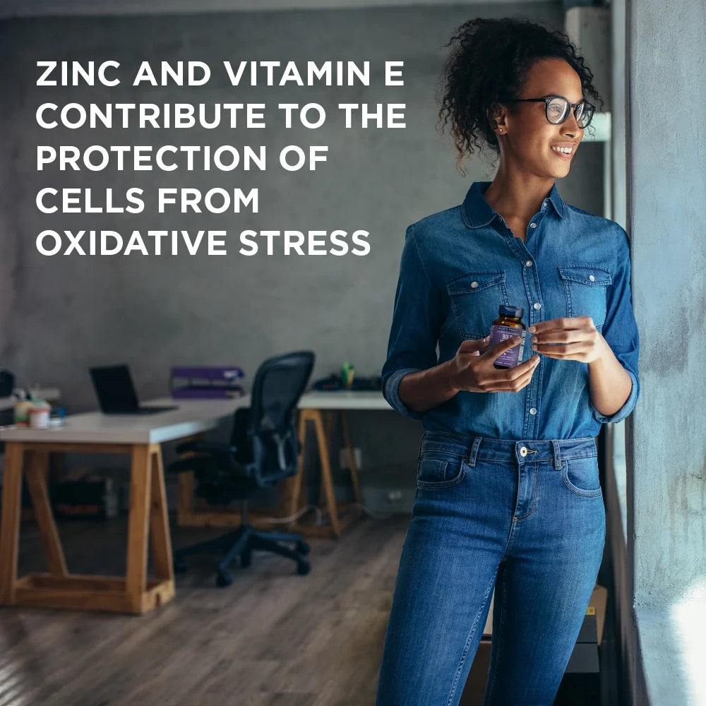 Woman holding BOLD VISION capsules with zinc and vitamin E antioxidant claim