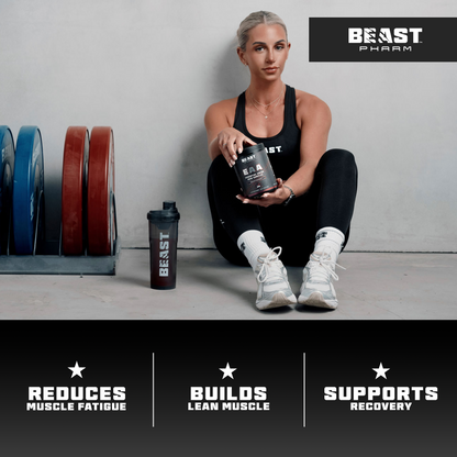 Woman holding a supplement container with Beast Pharm branding, surrounded by gym equipment.