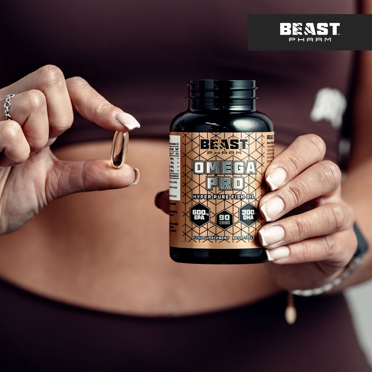 Person holding a Beast Pharm Omega 3 Pro supplement bottle