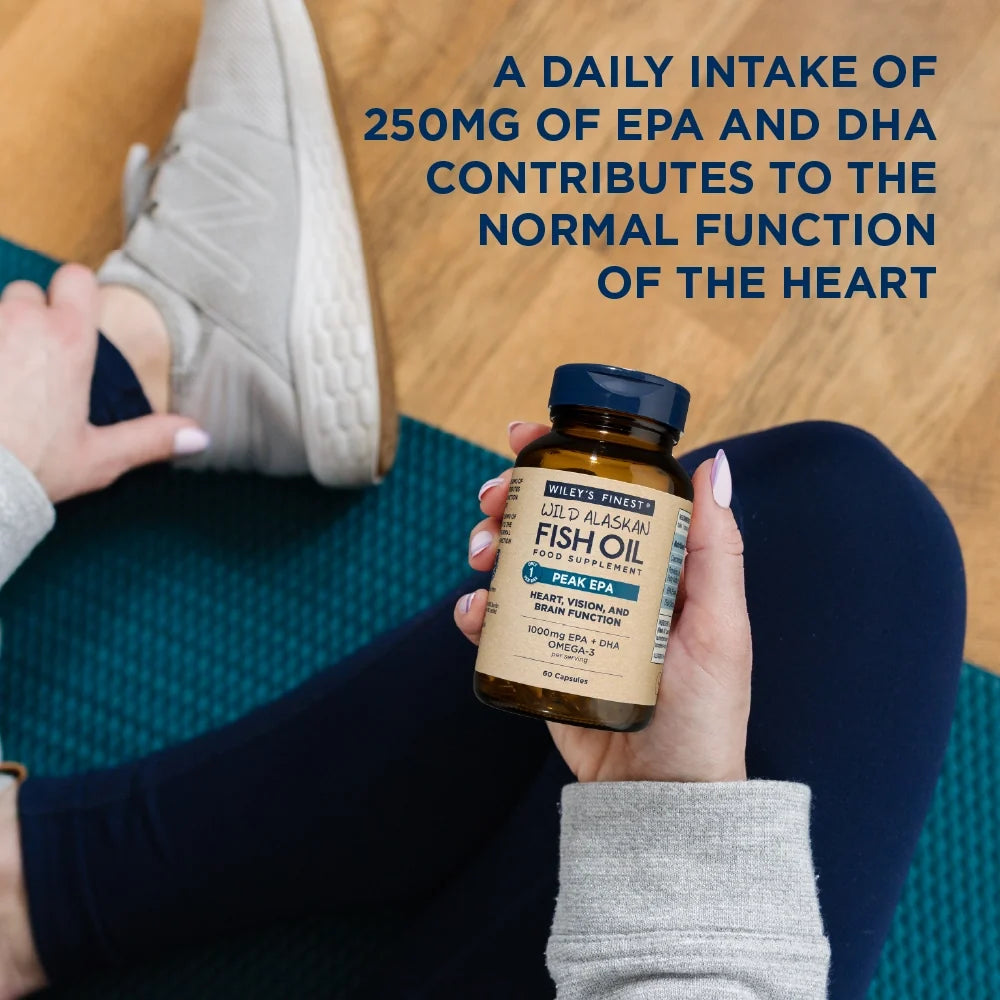 Person holding a bottle of fish oil supplement with text about EPA and DHA intake.