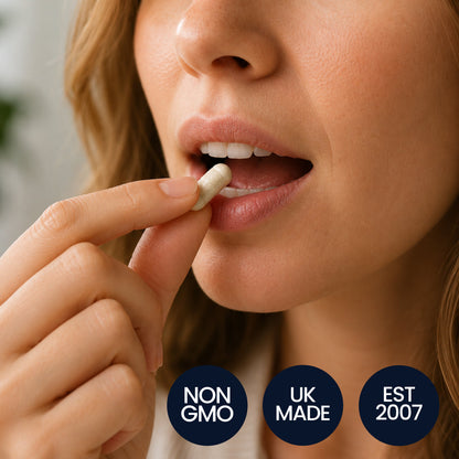 Woman taking a capsule with non-GMO, UK-made and established 2007 badges