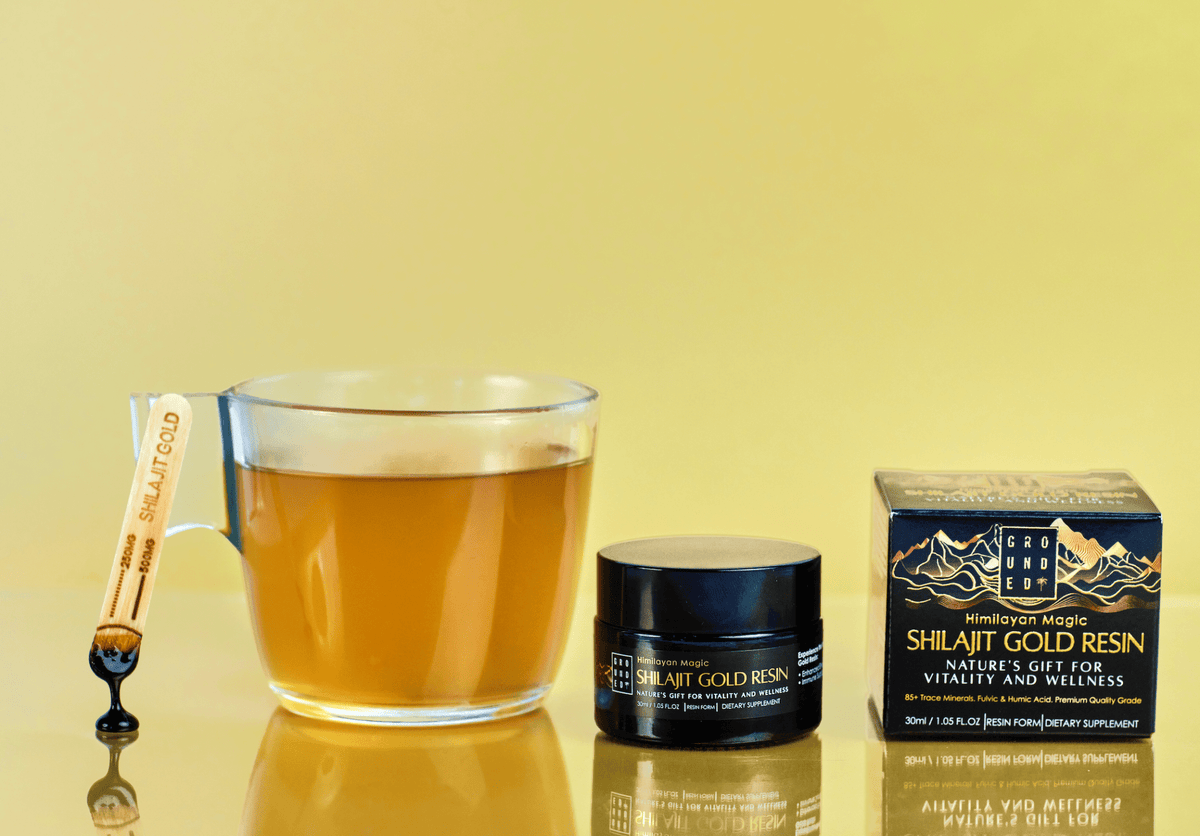Grounded Himalayan Magic Shilajit Gold Resin – 30ml – resin jar and spatula beside a drink