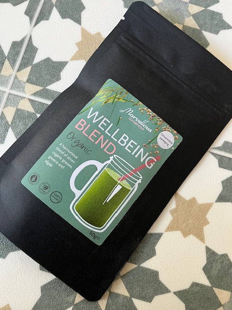Marvellous Superfood Organic Wellbeing Blend – pouch on patterned fabric