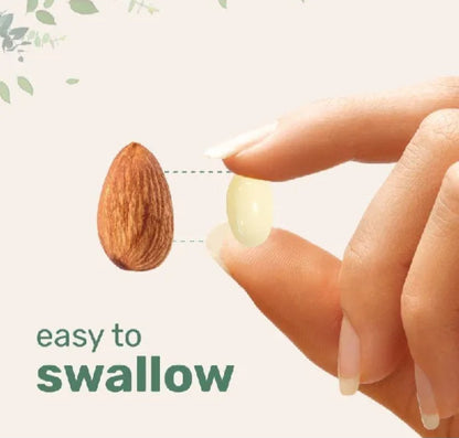 A hand holding a pale NAC softgel beside an almond for size comparison.