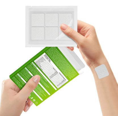 Person holding a green package with a white patch, showing the patch on their wrist.